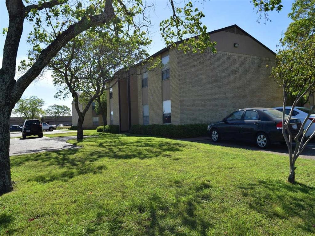 a large brick building with cars parked outside of it