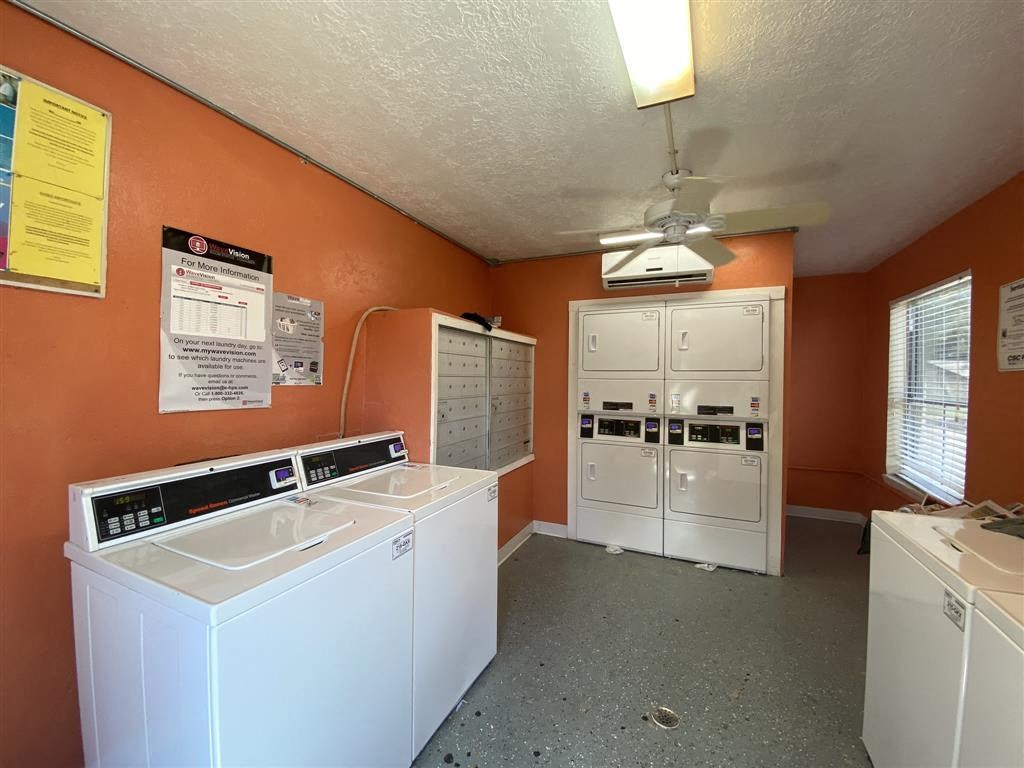 a laundry room with two washers and two washing machines