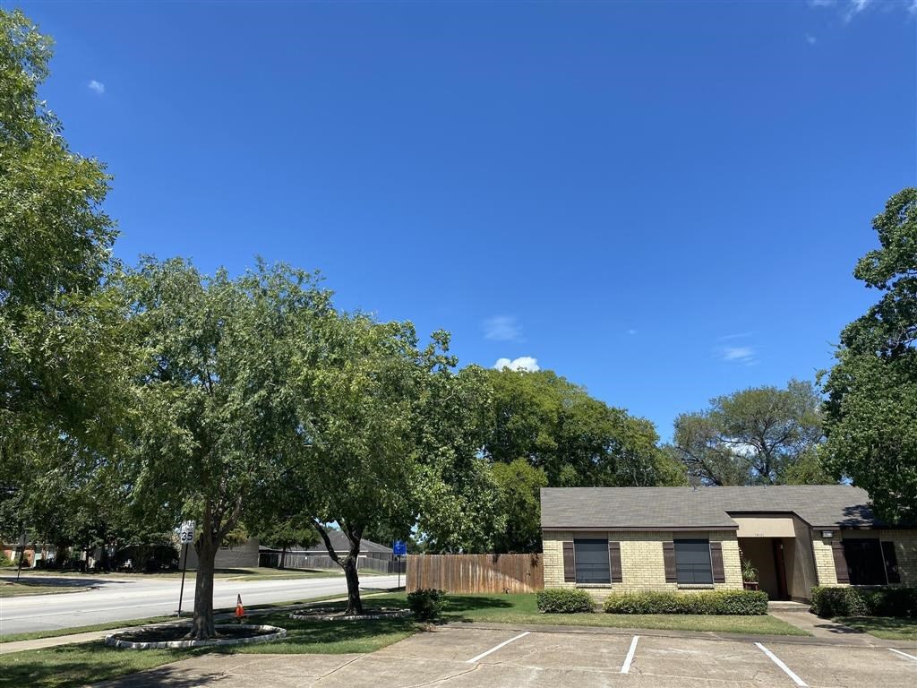 an empty parking lot in front of a house