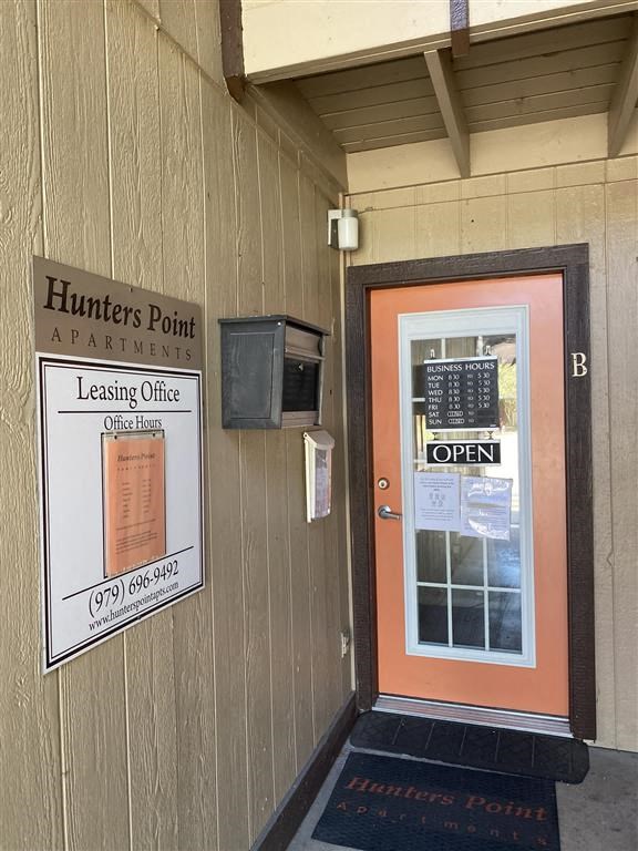 a door to a building with an open sign