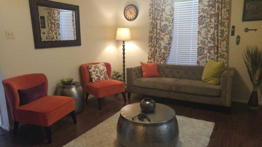 a living room with a couch and chairs