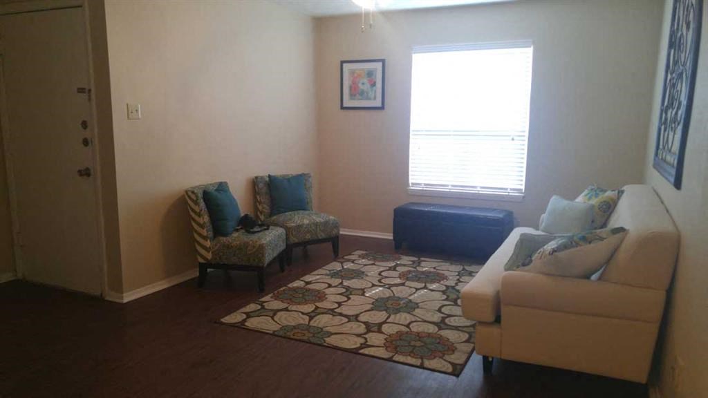 a living room with a couch and two chairs