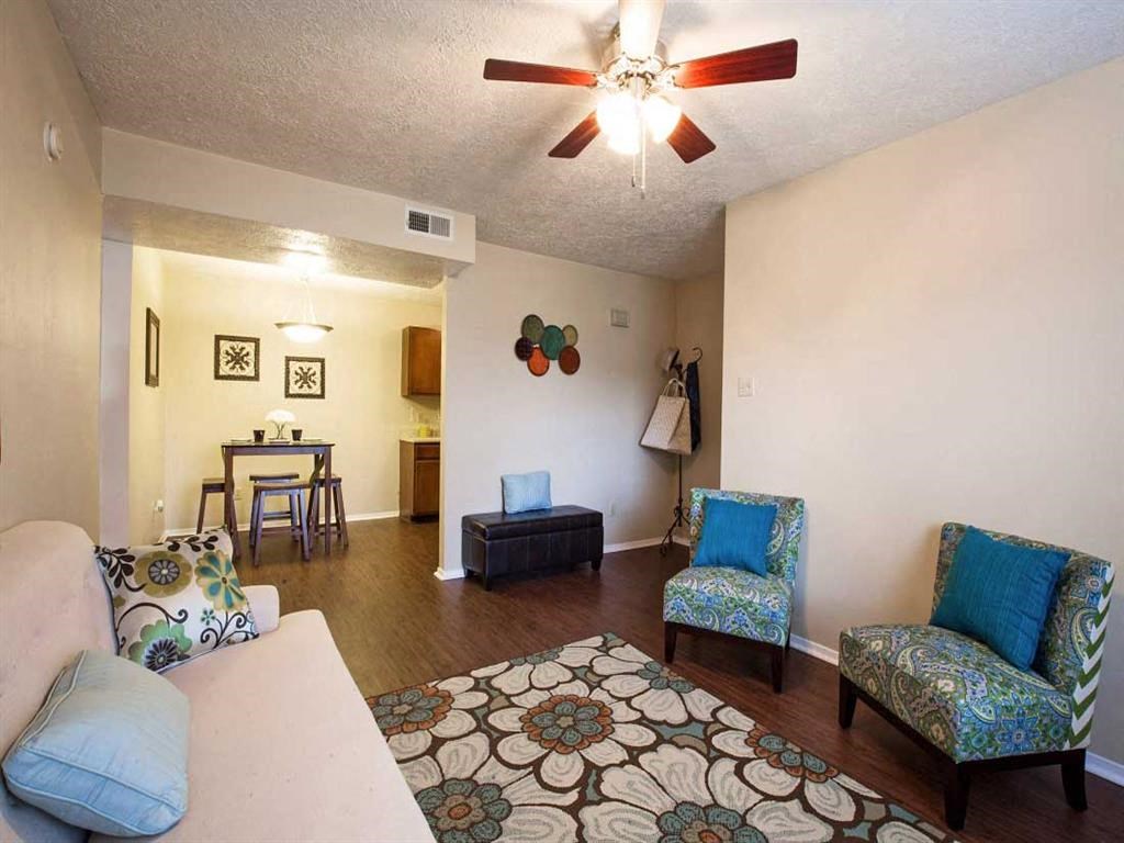 a living room with furniture and a ceiling fan