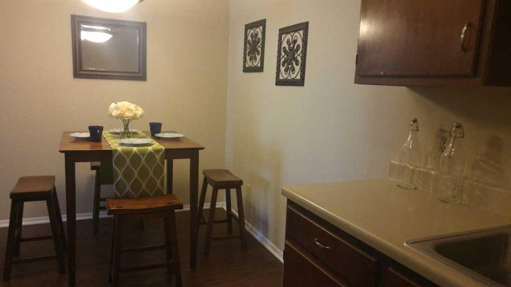 a kitchen with a table and chairs and a sink