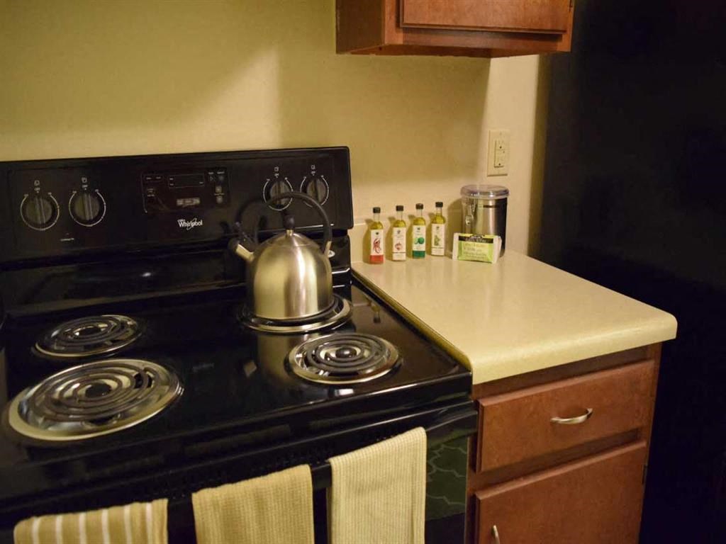 a kitchen with a stove and a kettle on the stove