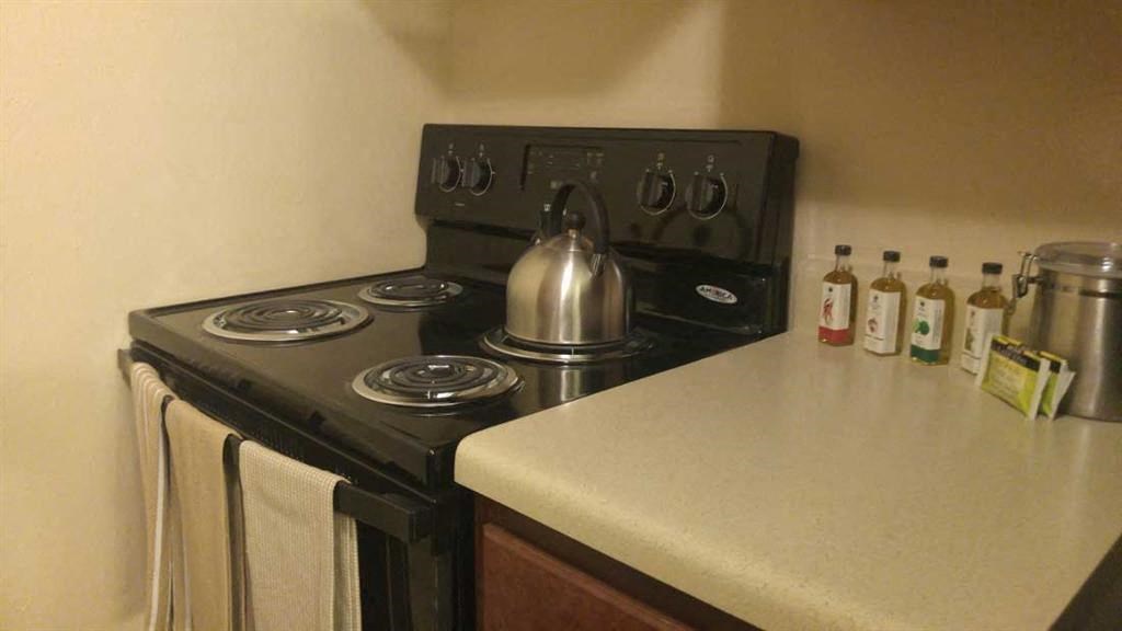 a kitchen with a stove and a kettle on it