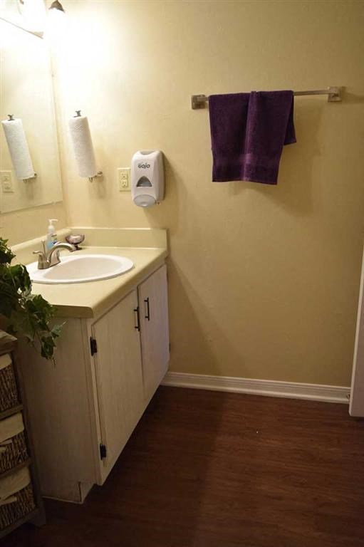 a bathroom with a sink and a towel rack