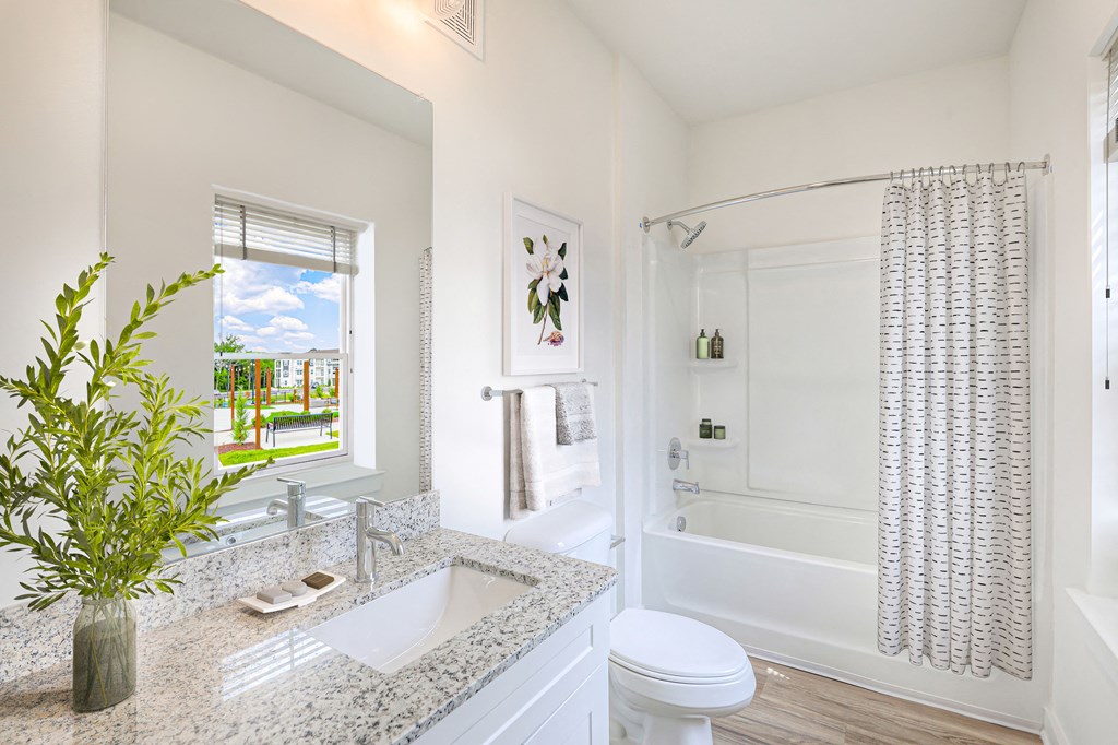 a bathroom with a sink and a toilet and a shower