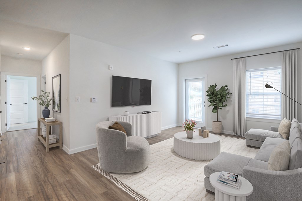 a living room with couches and chairs and a tv