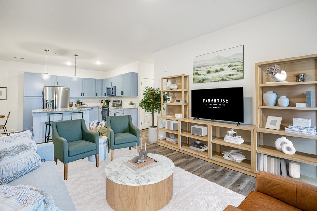 a living room with a couch and chairs and a tv
