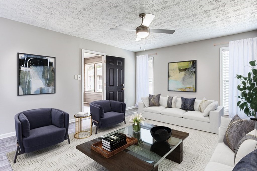 a living room with a couch and chairs and a coffee table