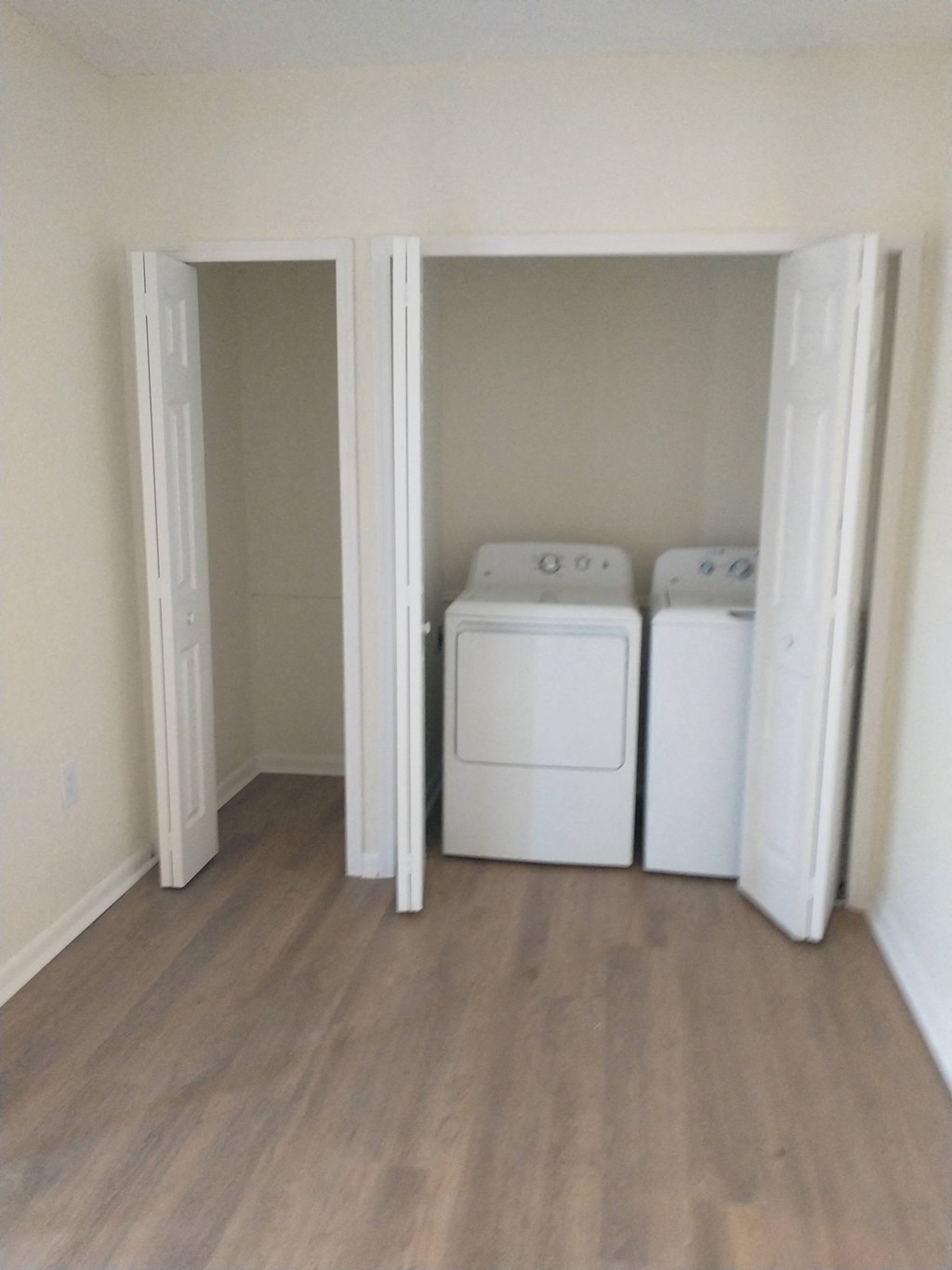 an empty laundry room with two washer and dryers in it at The Essex, Altamonte Springs, FL