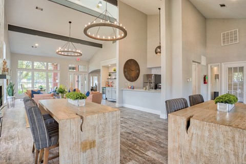 A modern dining room with a large wooden table and chairs.