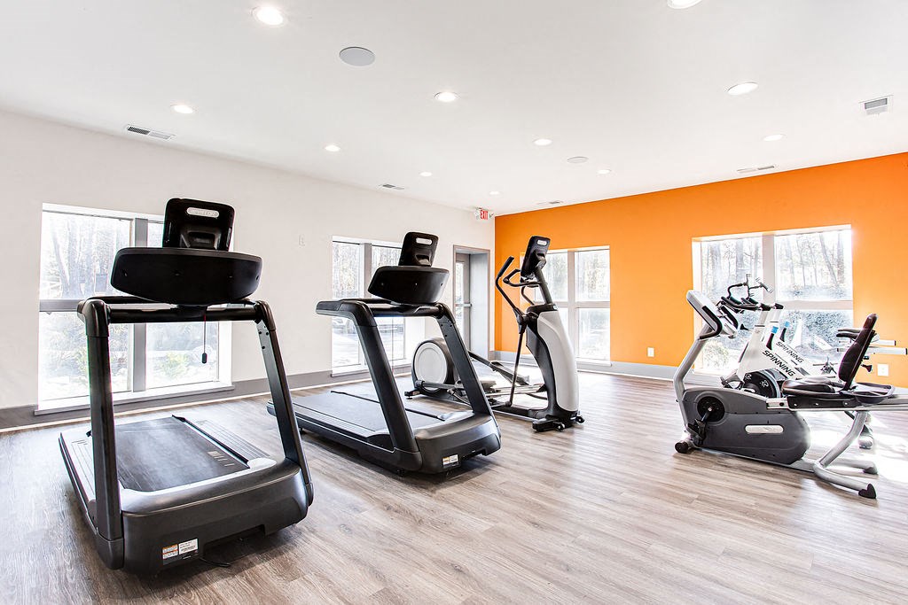 a gym with treadmills and other exercise equipment