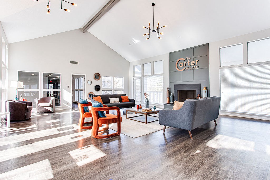 a living room with couches and chairs and a fireplace