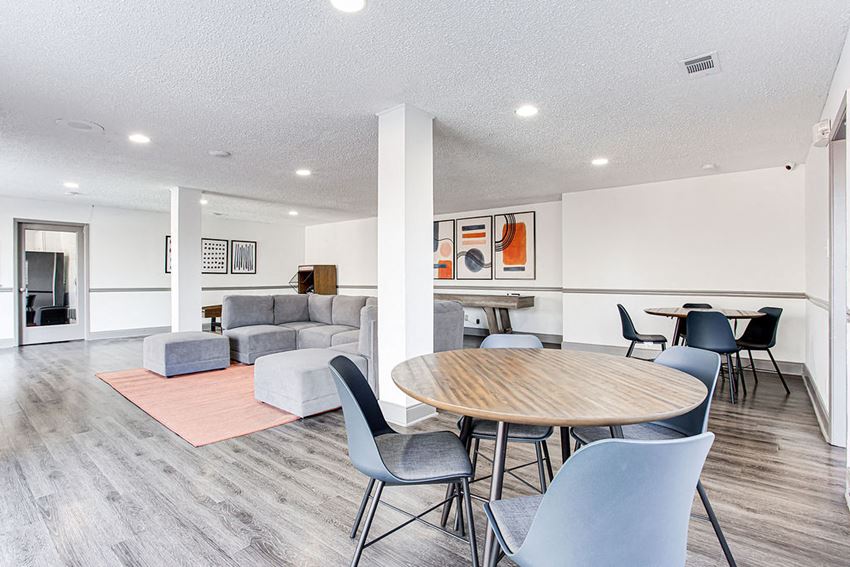 a living room and dining room with a table and chairs