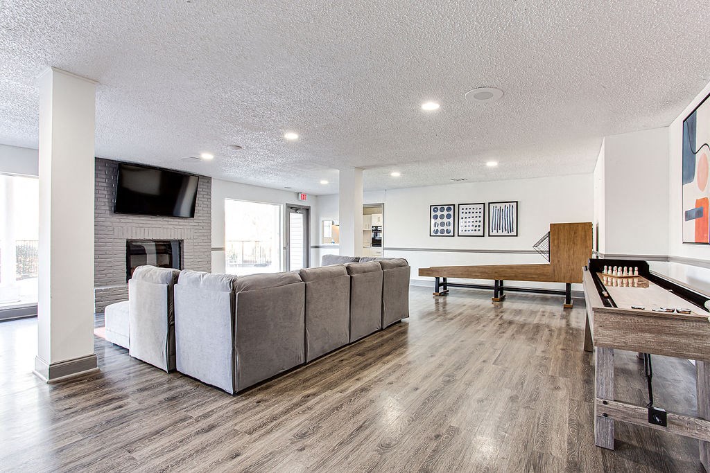 a living room with a couch and a pool table