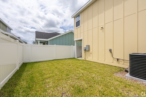 Backyard of a unit with a white fence