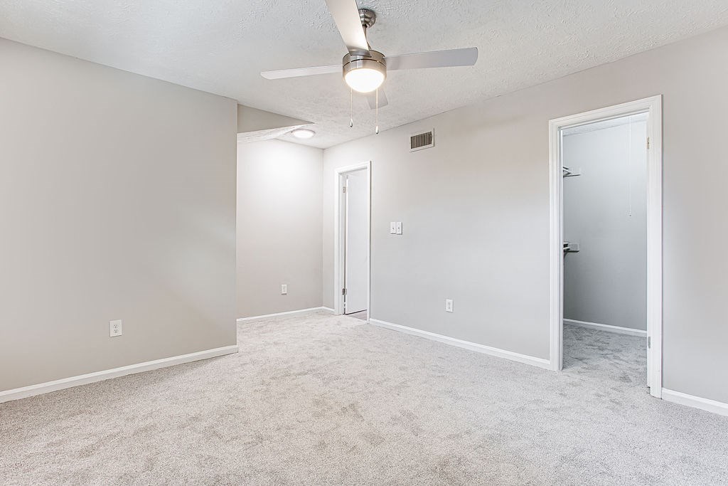 an empty bedroom with a ceiling fan at The Ellis Apartments, Clarkston, 30021