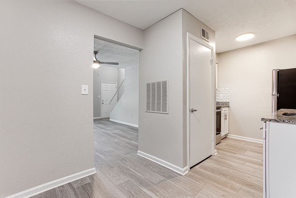 a bedroom with a medium sized window next to a kitchen at The Ellis Apartments, Georgia