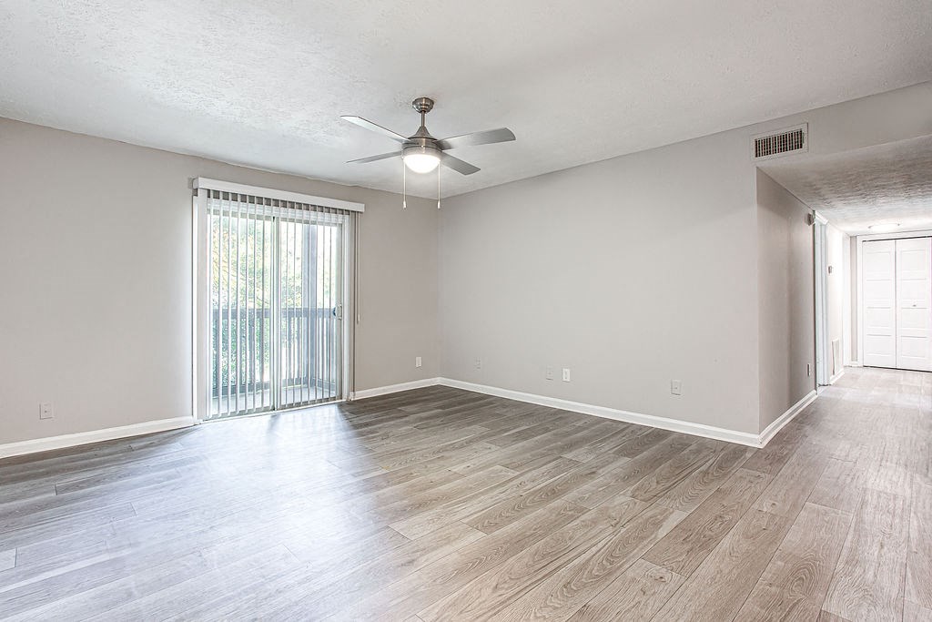 a bedroom with hardwood floors and a ceiling fan at The Ellis Apartments, Clarkston, GA