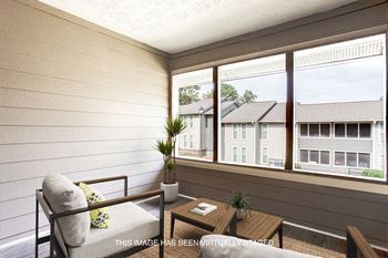 a small porch with a couch and a table