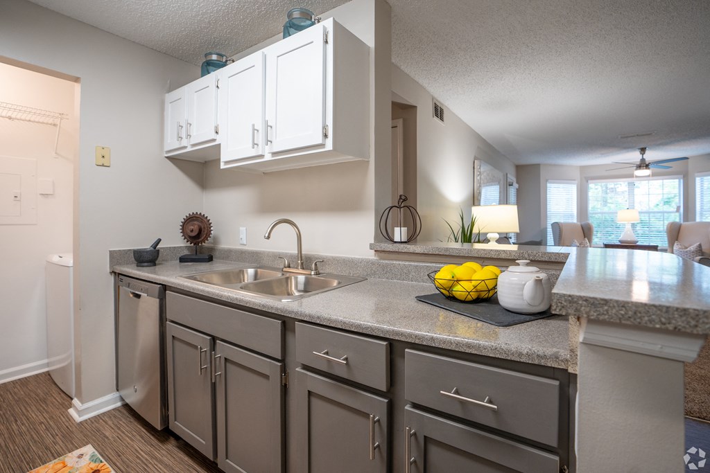 an open kitchen with stainless steel appliances and a large counter top