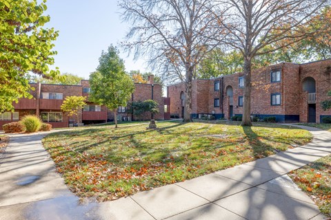 A brick building with a tree in front of it.