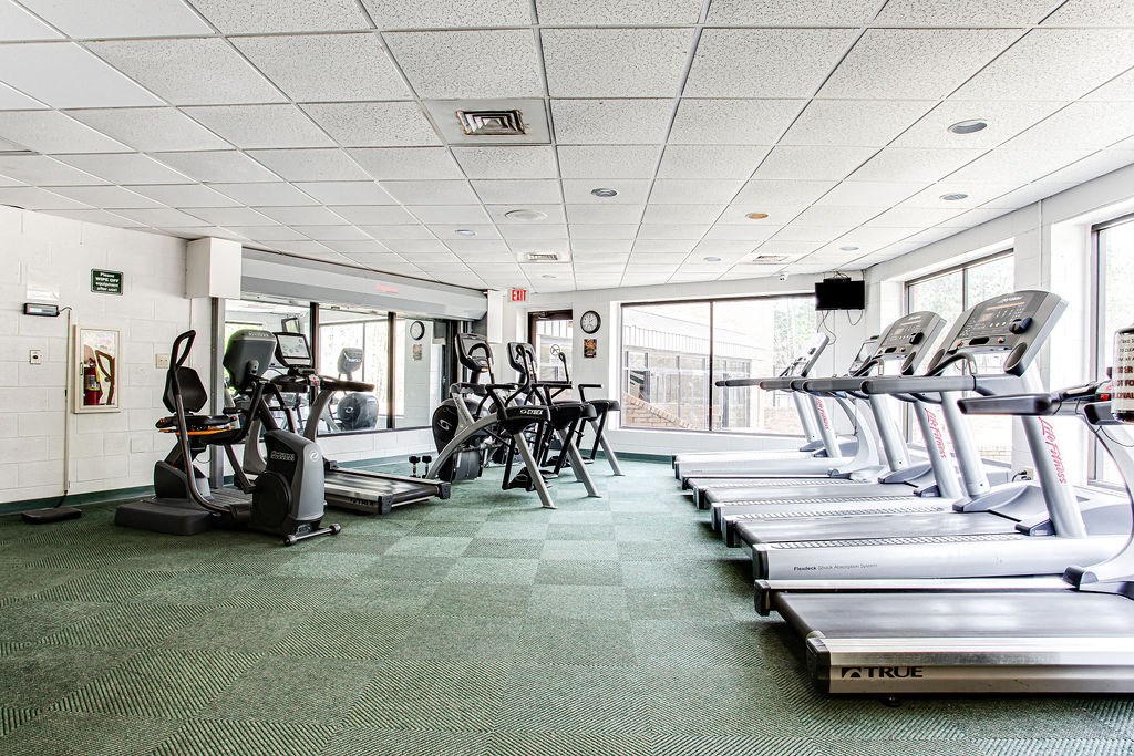 a large fitness room with treadmills and elliptical trainers at Lory of Harbison, Columbia, SC, 29212
