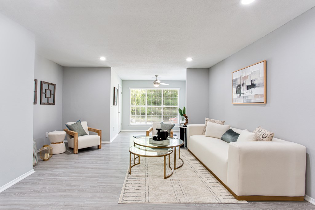 a living room with a white couch and a table at Parc at 1875, College Park