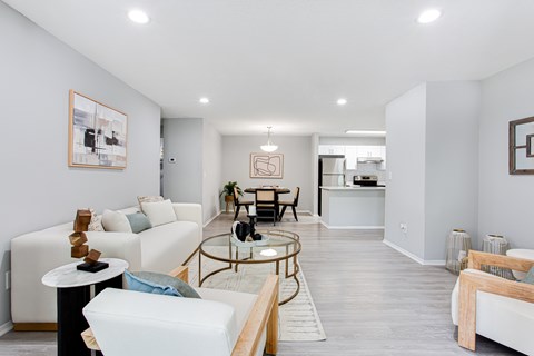 A living room with a white couch and a coffee table.