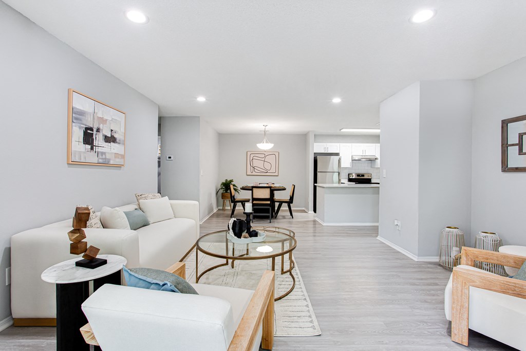 a living room with white couches and a table at Parc at 1875, College Park, Georgia