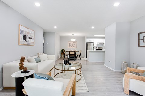 A living room with a white couch and a coffee table.