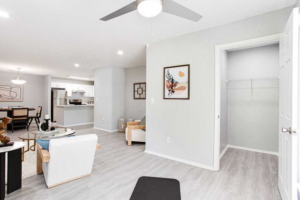 a living room and dining room with a ceiling fan at Parc at 1875, Georgia