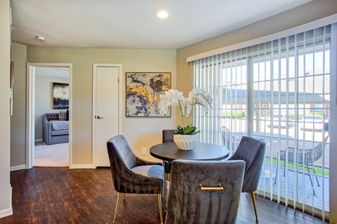 A dining room with a table and chairs.