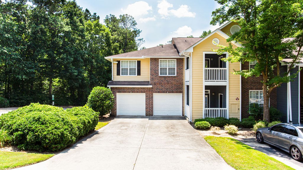 a house with a long driveway and a car parked in the driveway