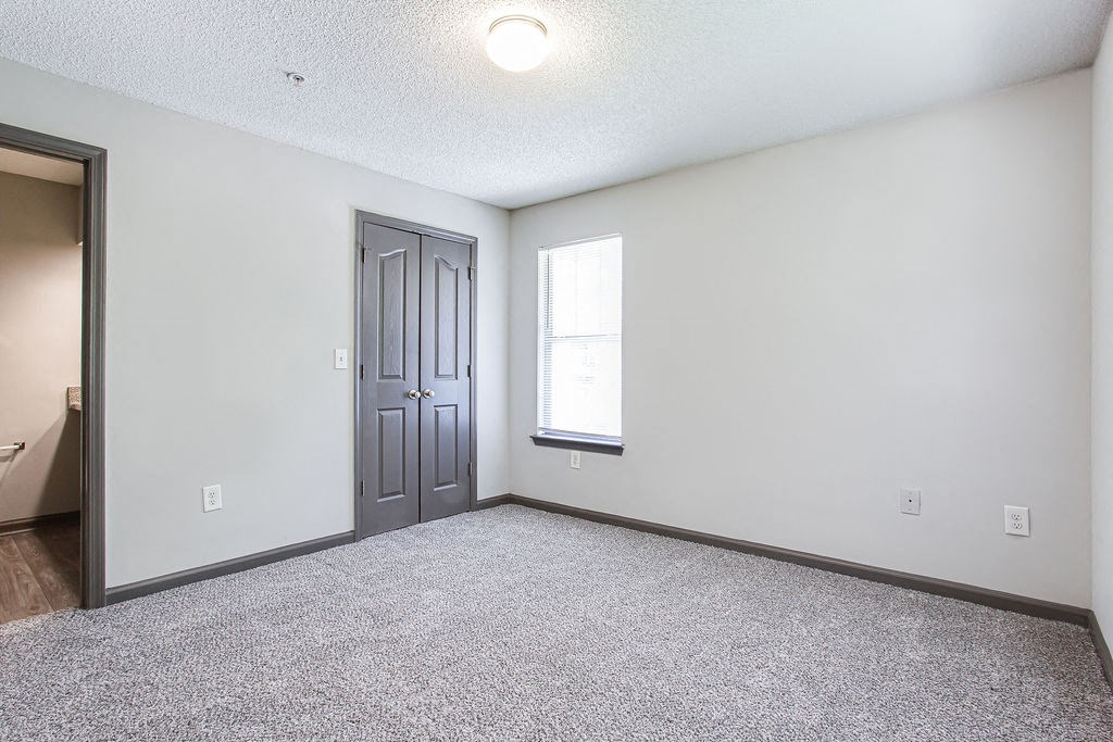 an empty room with a door and a window