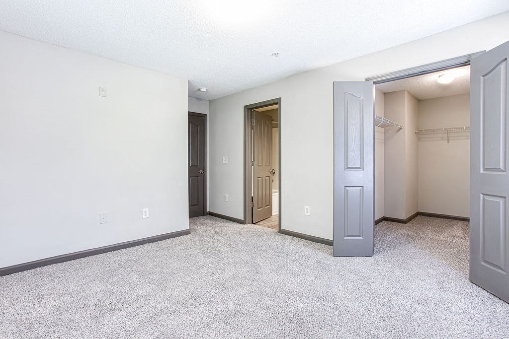 a bedroom with a closet and an open door