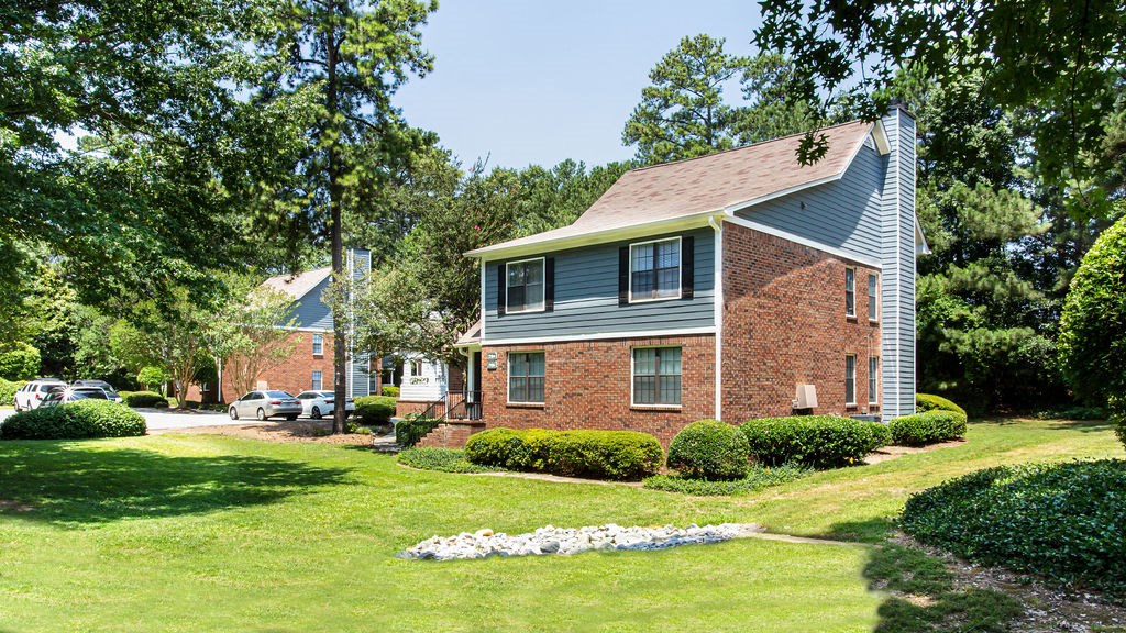 a house on a hill with a grassy area in front of it