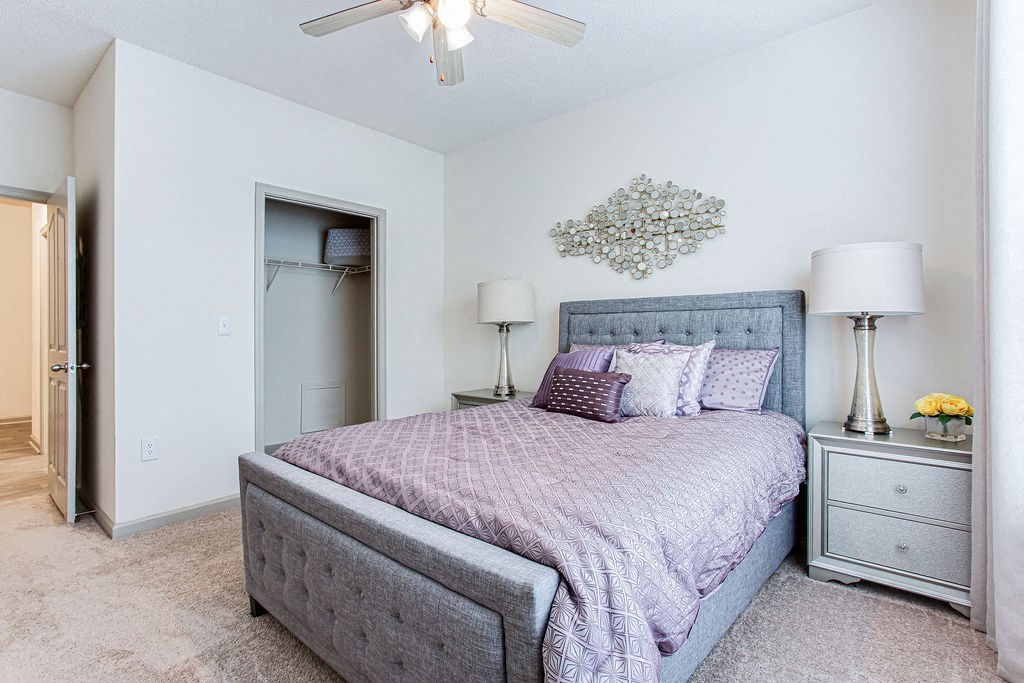 a bedroom with a bed and two night stands