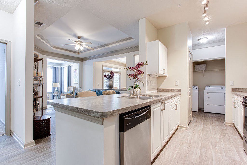 a kitchen with white cabinets and a large island