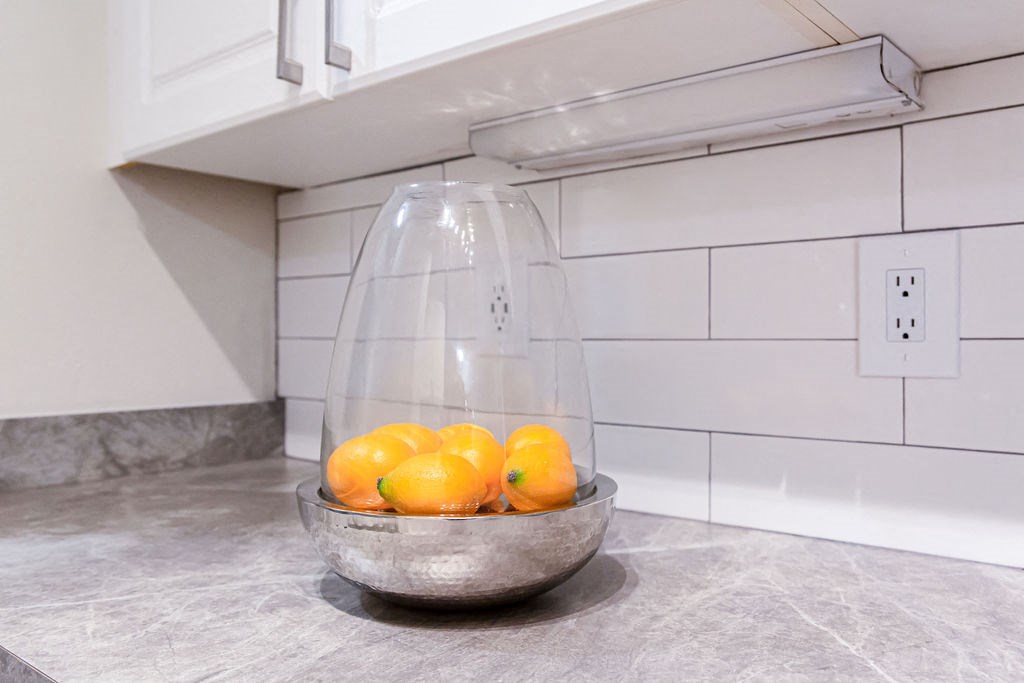 a bowl of lemons in a kitchen