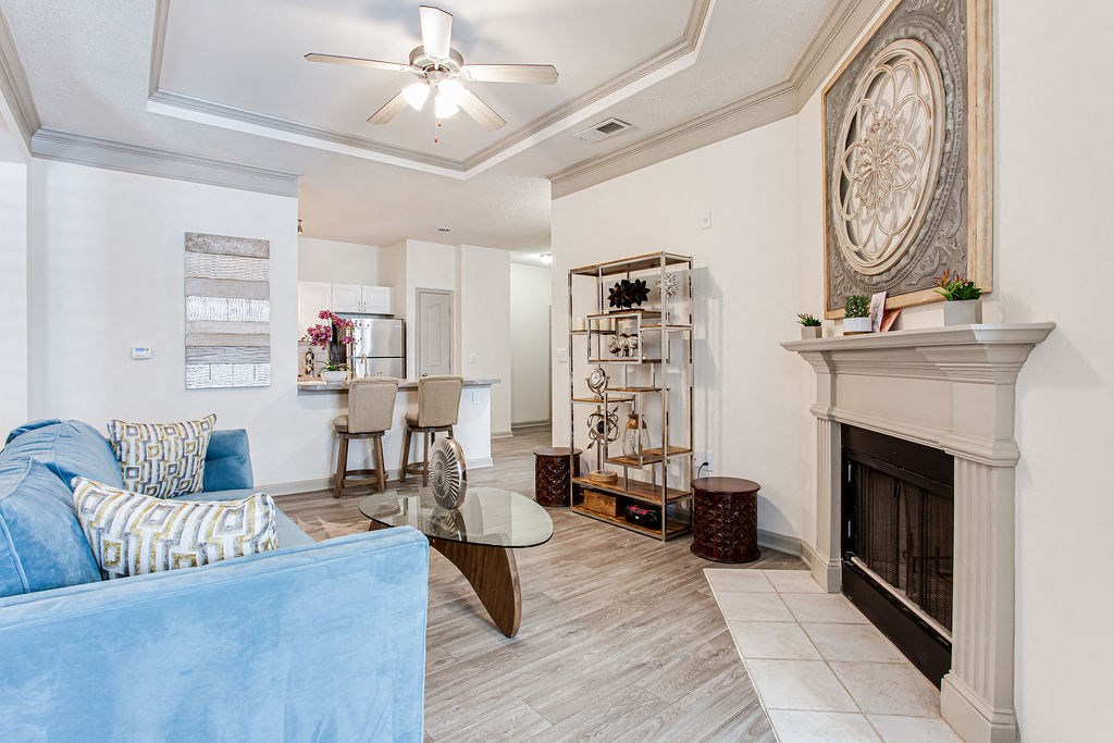 a living room with a fireplace and a blue couch