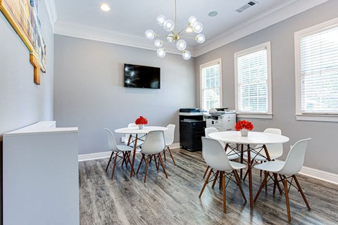 a dining room with a table and chairs and a kitchen