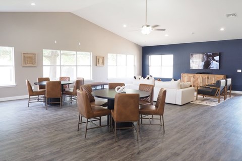 A modern dining room with a large table and chairs.