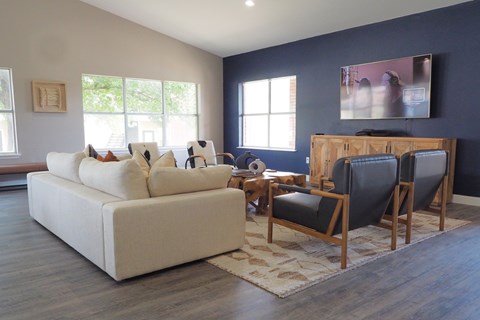A living room with a white couch and a wooden coffee table.