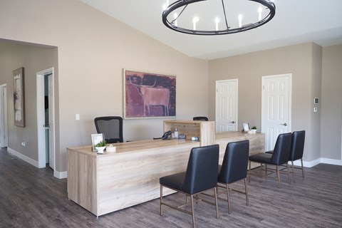 A reception area with a wooden desk and chairs.