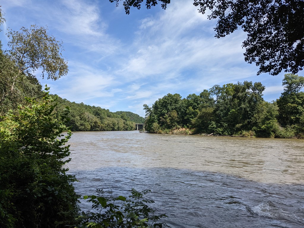 a bridge over a river surrounded by trees at Vinings RiverVue Apartments, Atlanta, GA