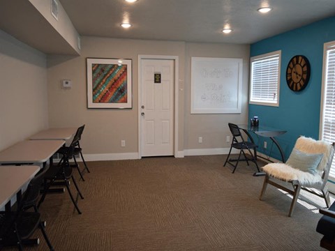 a conference room with tables and chairs and a blue wall