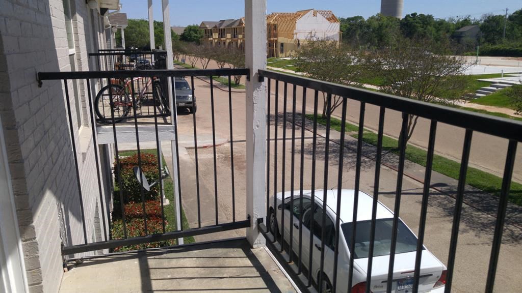 a white car parked on the side of a balcony